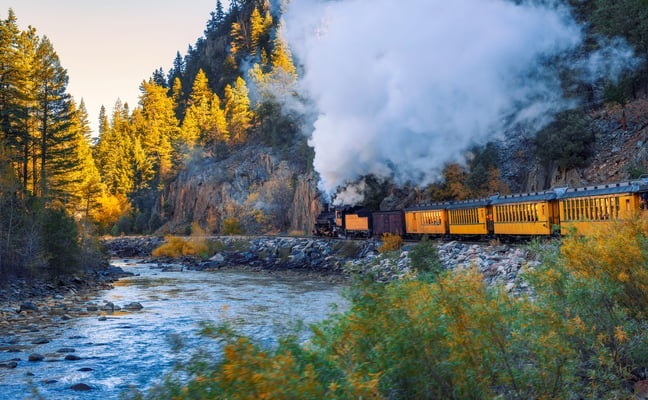 Durango Narrow Gauge train steaming along the Animas River in fall